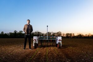 Male mechanical engineer with agricultural robot
